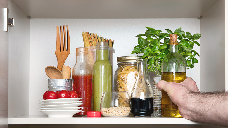 hand reaching for olive oil