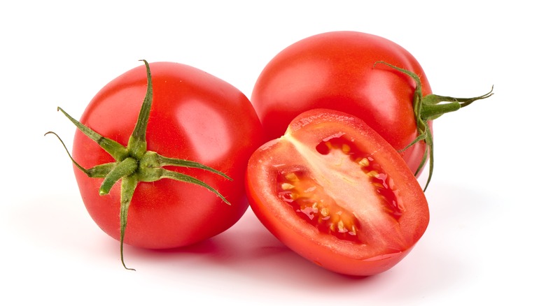 cut tomatoes on white background