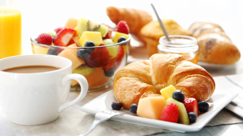 fruit, croissants, juice, and coffee