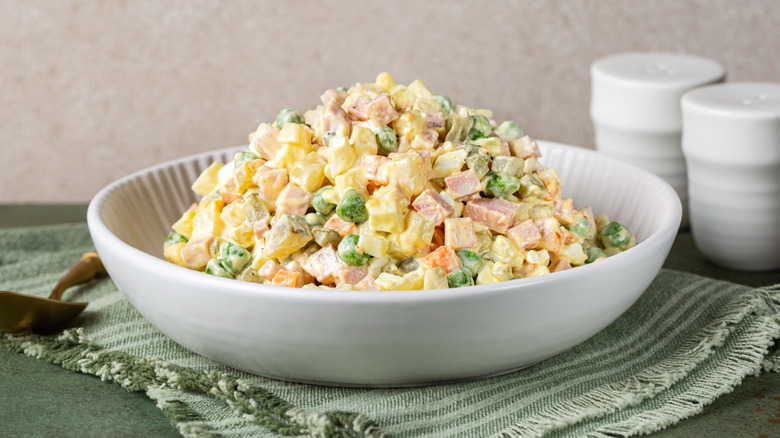 Olivier salad in a white bowl