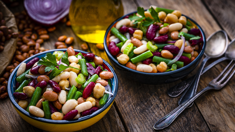 Five-bean salad in bowls on a wooden table