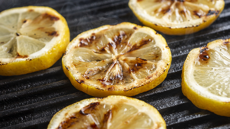 Sliced, grilled lemon wheels on a grill