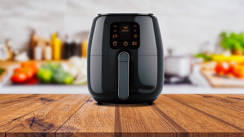 black air fryer on a wooden counter