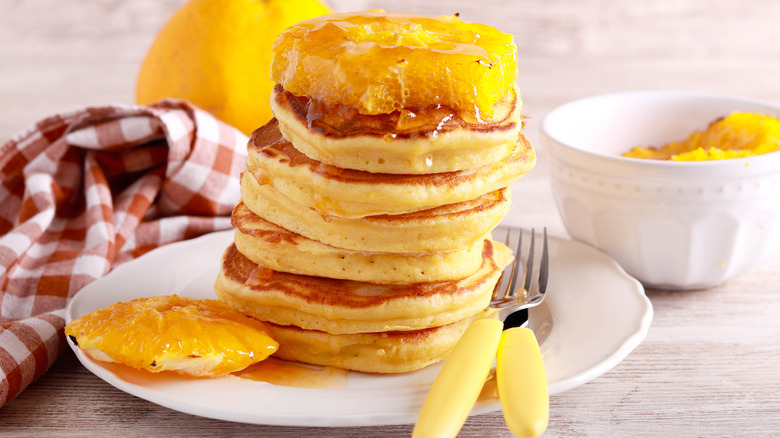 Ricotta pancakes with orange on a plate