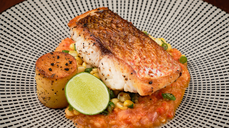 Salmon with crispy skin and vegetables on a plate