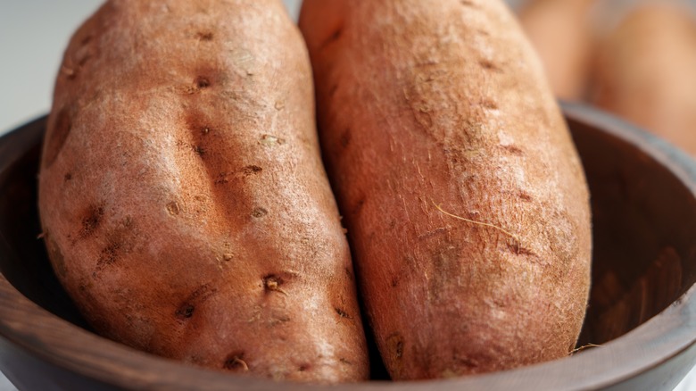 Whole sweet potatoes in bowl