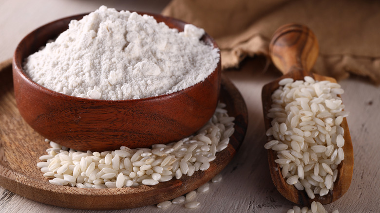 Rice flour next to a scoop of rice