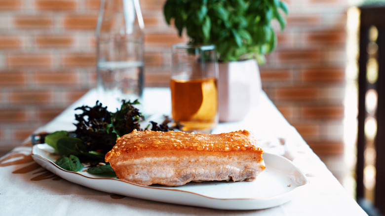 plate of crispy pork belly with salad