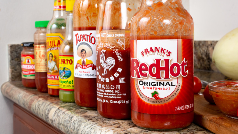 a line of hot sauce brands, Frank's RedHot at the front