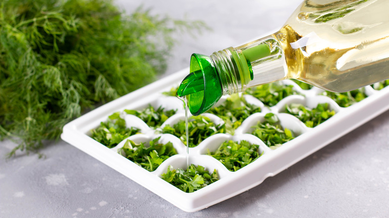 pouring oil over chopped herbs