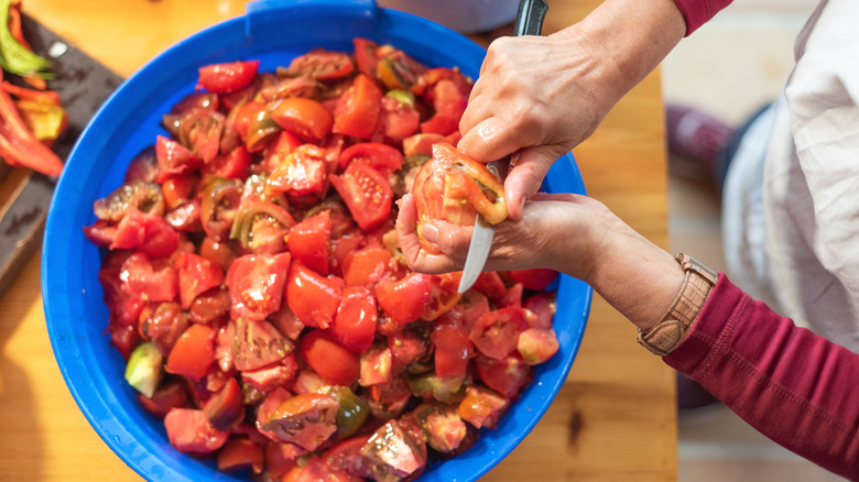 Prepping large bowl of tomatoes