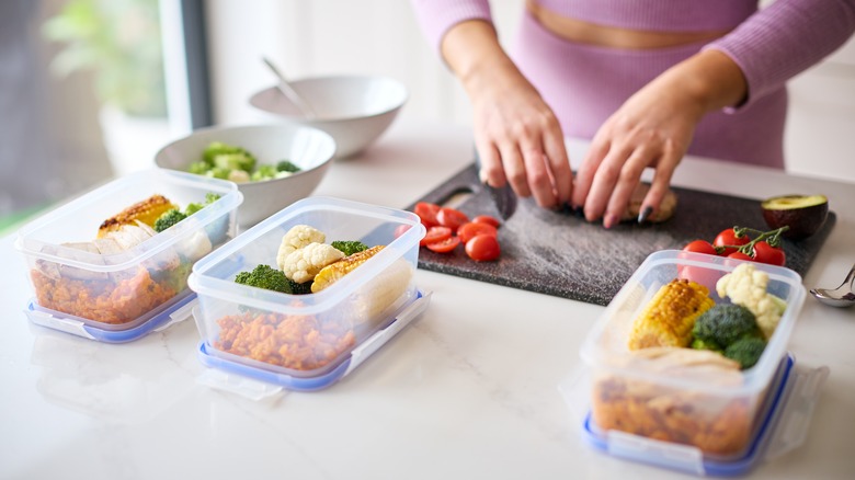 Woman preparing meals in tubs