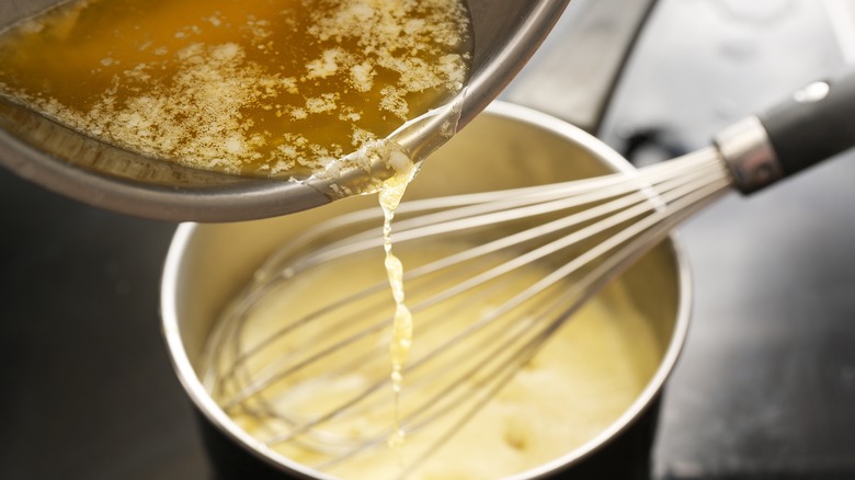 Butter being poured into a saucepan