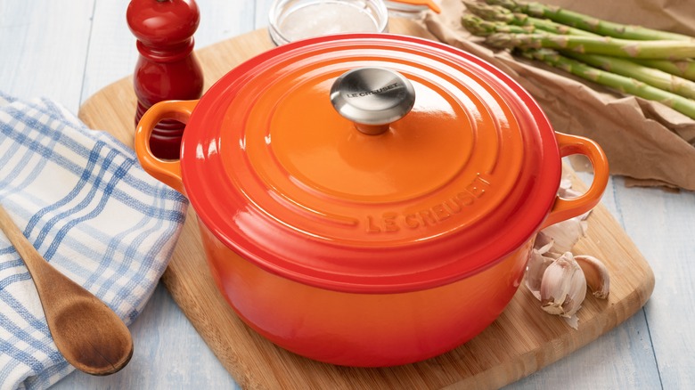 a dutch oven on a cutting board