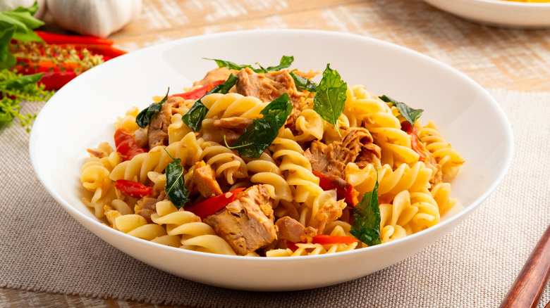 Pasta topped with fried basil leaves