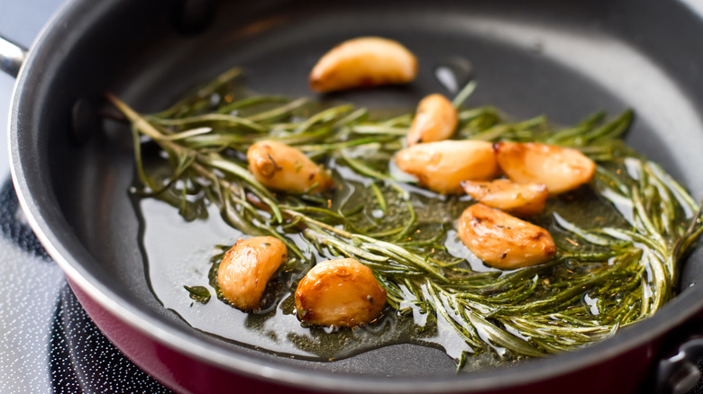 Rosemary fried in oil with garlic cloves