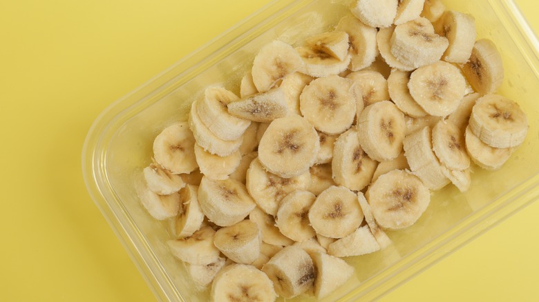 rectangular tupperware filled with frozen banana slices