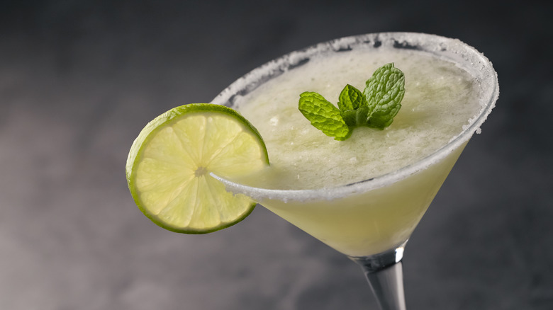 A frozen daiquiri with a wheel of lime on its glass