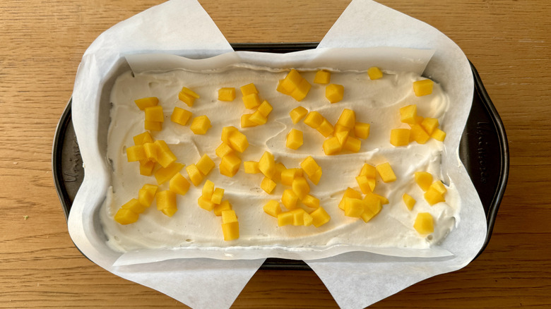 whipped cream and chopped mango in loaf pan