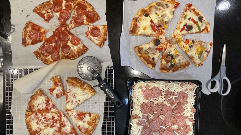 Four pizzas being tasted 