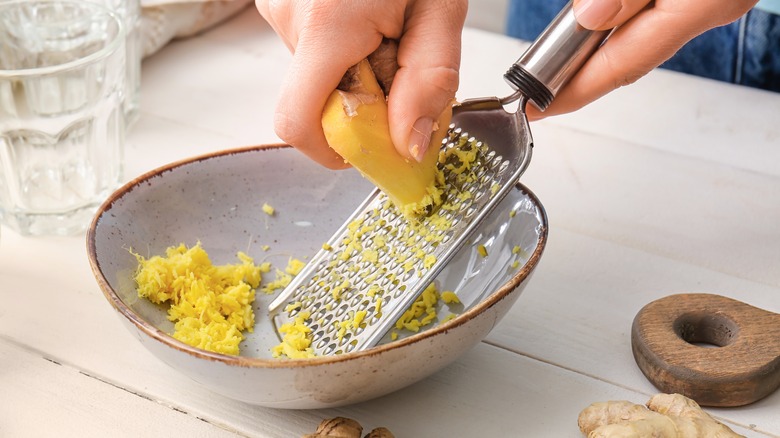 Grating ginger into bowl