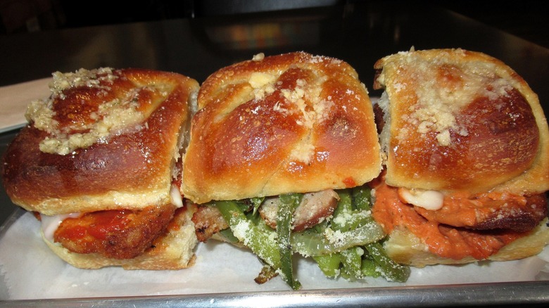 Chicken Parmesan sandwich held together by garlic knots