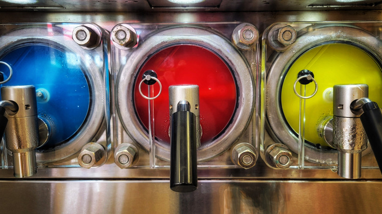 Blue, red, and yellow slushy machines