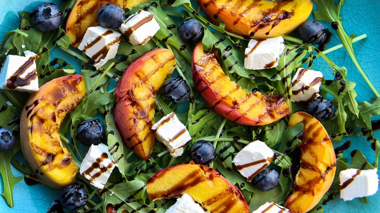 Grilled peaches over salad