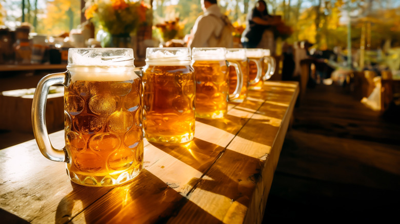 Steins of beer on wooden table