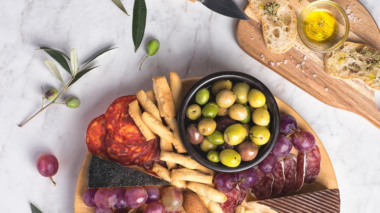 Charcuterie board with olives and bread