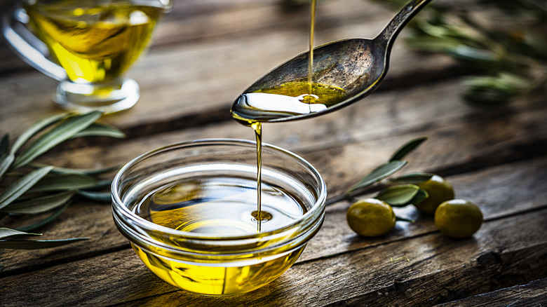 pouring olive oil into bowl