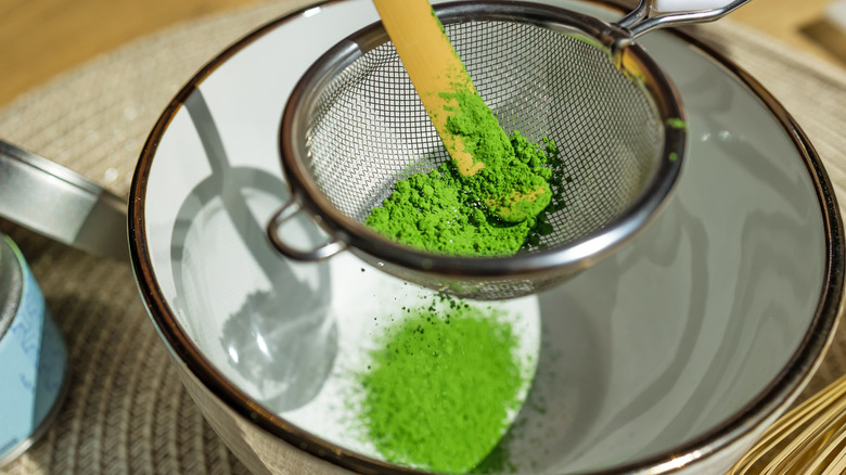 matcha powder being prepared in a bowl
