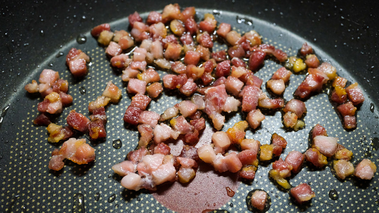 Crispy bacon pieces in a pan