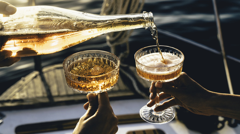 Champagne pouring into two glasses