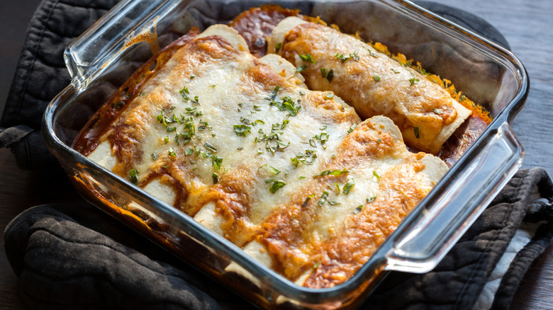 enchilada burritos in a glass casserole dish
