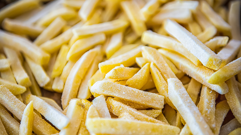 Closeup of frozen fries on a sheet tray