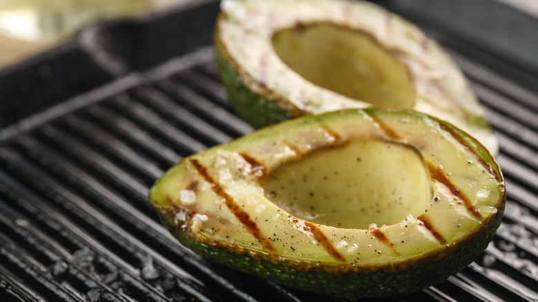 Sliced fresh avocado on grill