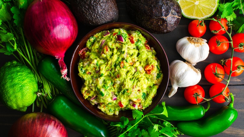 Guacamole surrounded by ingredients