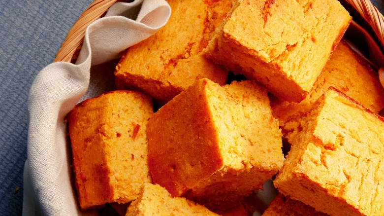 Sweet potato cornbread pieces are arranged in a basket.