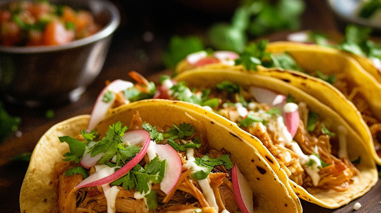 tacos garnished with cilantro and radishes