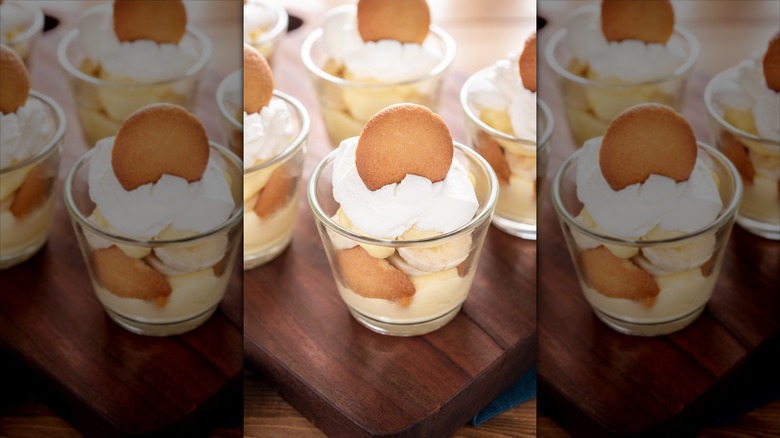 Small cups of banana pudding with vanilla wafers and whipped cream