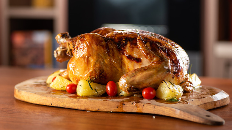 Roasted turkey on wooden serving tray