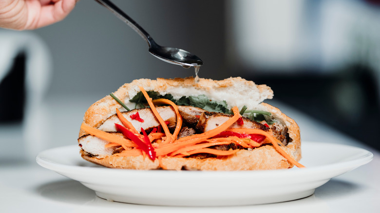 banh mi drizzled with sauce in restaurant