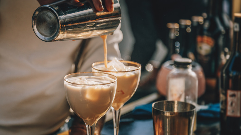 bartender pouring two cream coffee cocktails 