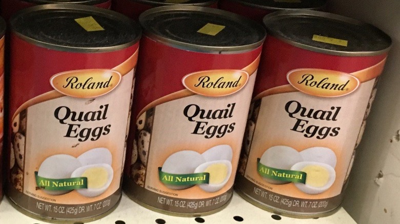 Row of canned quail eggs at grocery store