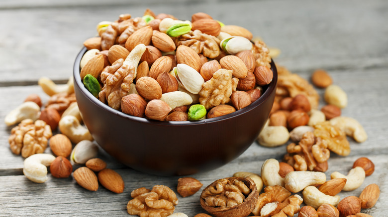 Mixed nuts and seeds in bowl on table