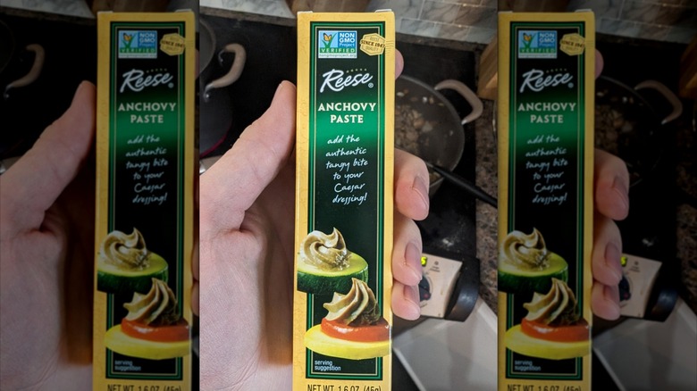 Person holding box of anchovy paste