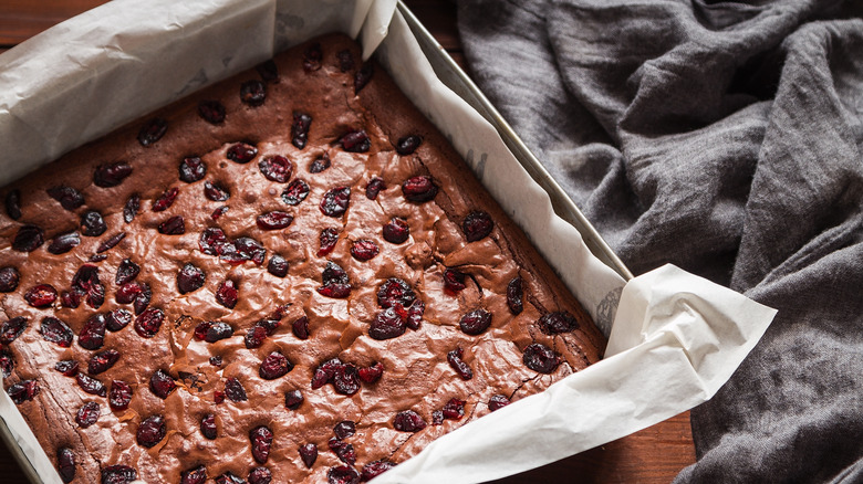 Metal pan with parchment paper and brownies