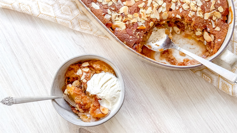 Gluten-free peach cobbler in bowl with vanilla ice cream and in serving dish