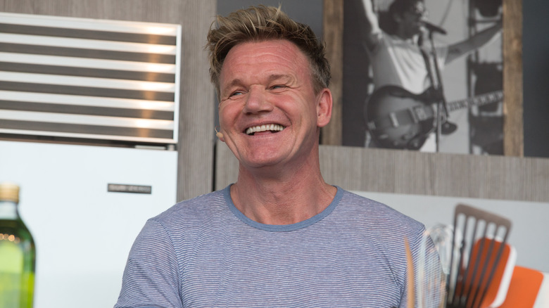 Chef Gordon Ramsay smiling in a demo kitchen